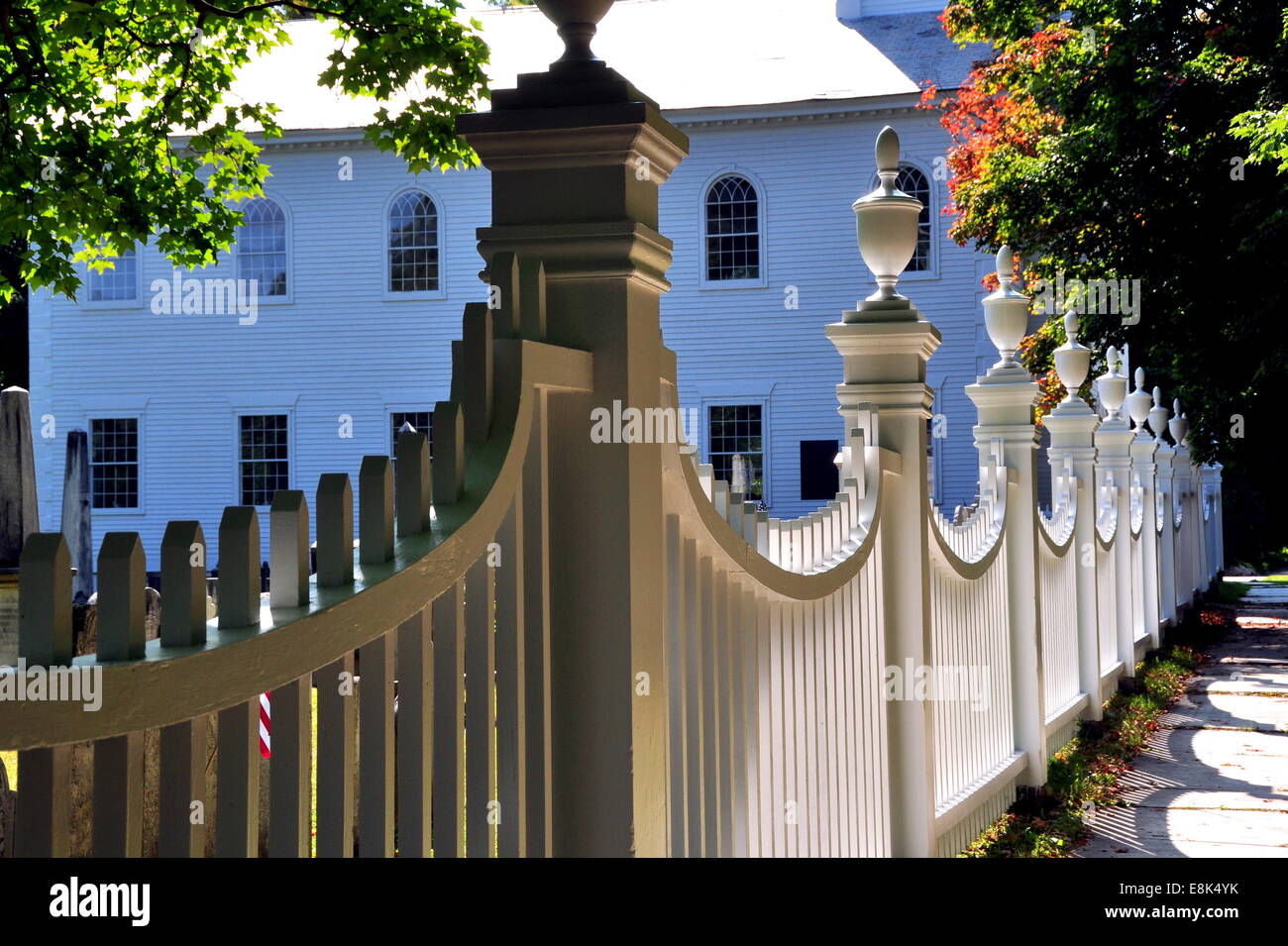 Bennington, Vermont:  An arched white fence with finials surrounds the old burial ground at the1806 First Congregational Church Stock Photo