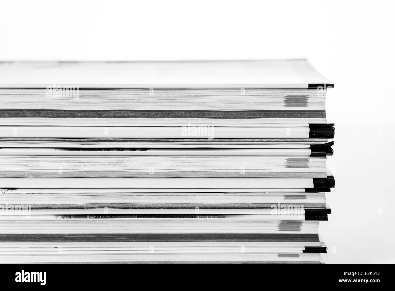 pile of five open books, placed on top of each other, open in the middle, white reflective surface, Stock Photo