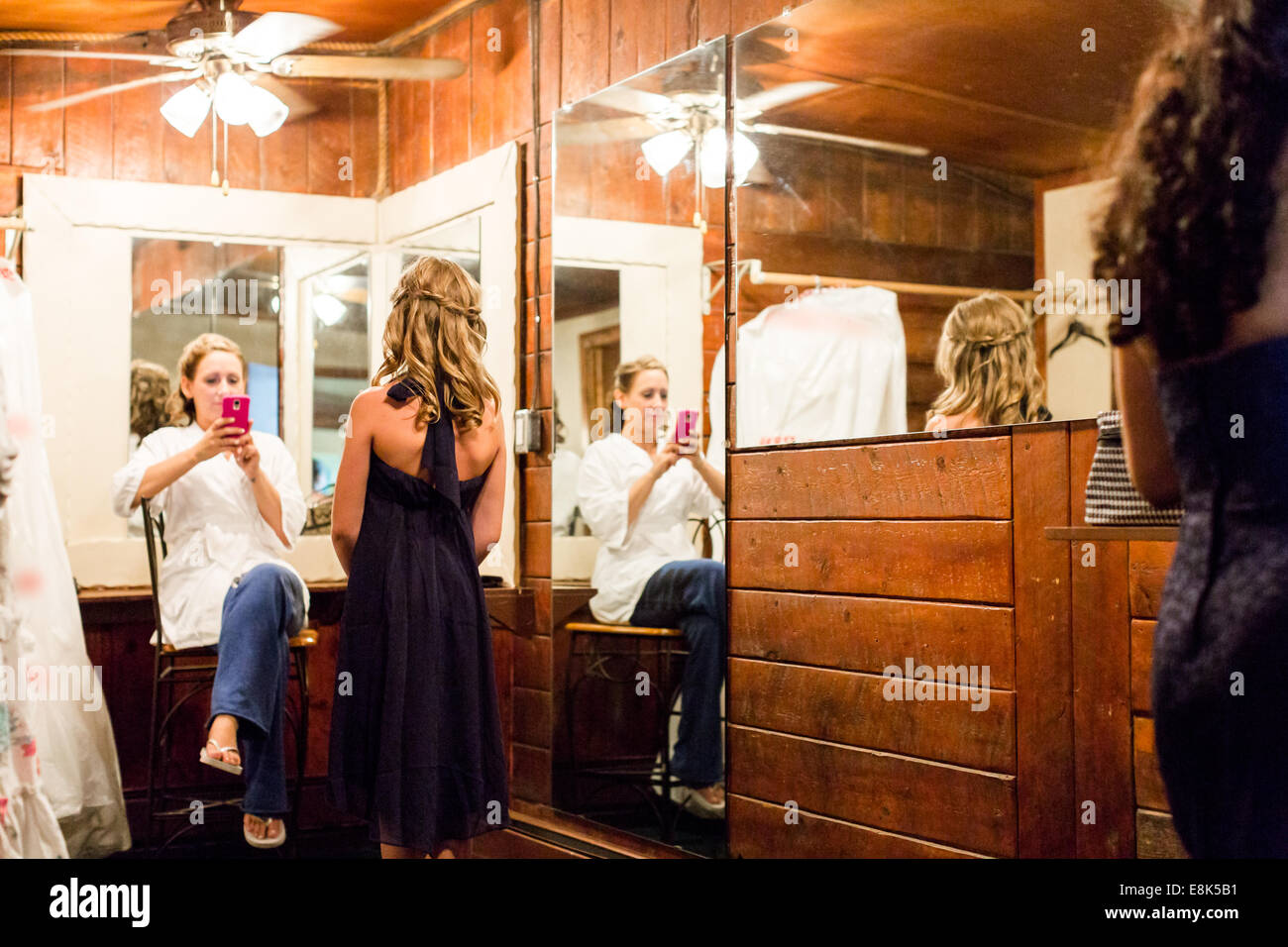 Bride Dressing Up For Her Wedding Dress With Help Of Brides Maids