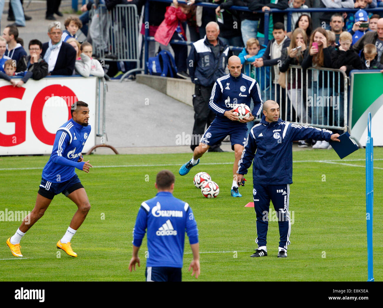 Geselnkirchen, Germany. 9th Oct, 2014. The new headcoach of German Bundesliga soccer club Schalke 04, Roberto di Matteo, leads his first training session in Geselnkirchen, Germany, 09 October 2014. Kevin-Prince Boateng (L) and assistant coach Attilio Lombardo (back) are pictured with him. Matteo takes over from Jens Keller. Photo: Roland Weihrauch/dpa/Alamy Live News Stock Photo