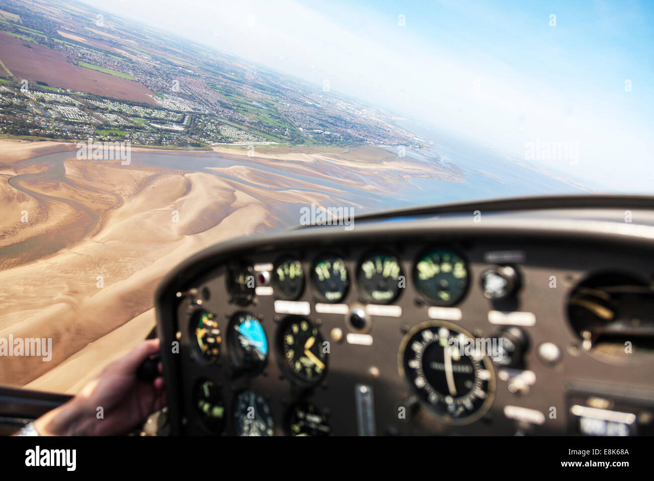 inside Bolkowl Junior Bo 208 G-BOKW 'C' model plane aircraft airplane looking down at Lincolnshire coast coastline from above Stock Photo