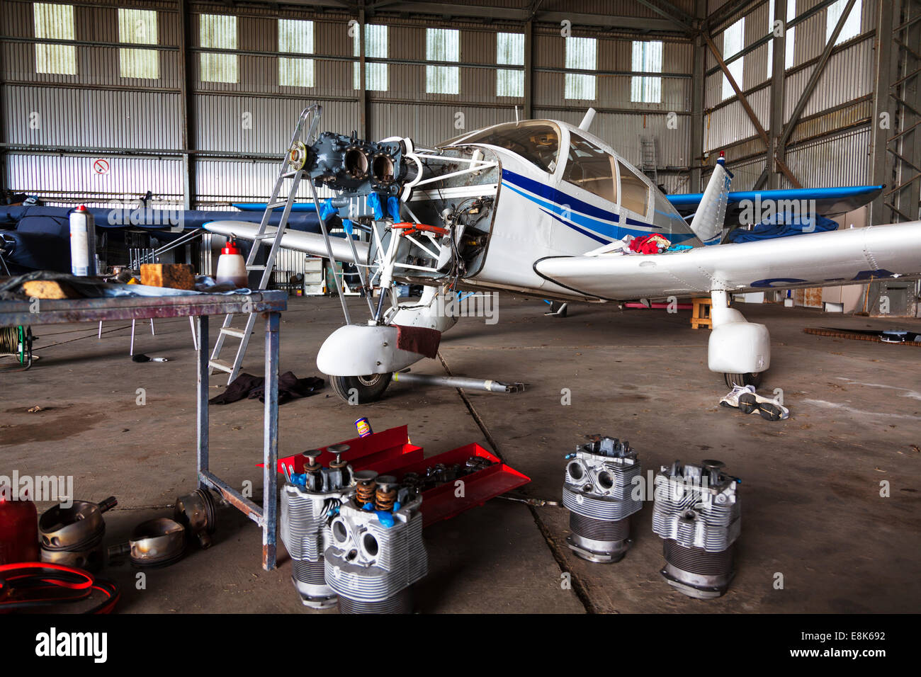 engine being worked on a Piper PA 28 plane light aircraft barrel piston dismantled in bits repair repairing  apart Stock Photo