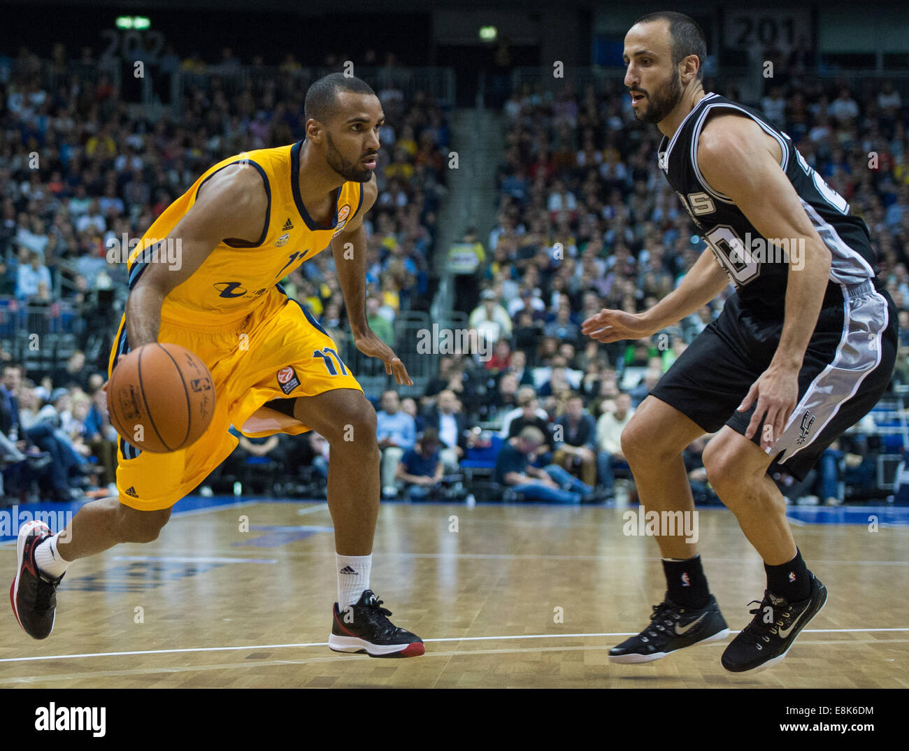 Berlin, Germany. 08th Oct, 2014. Akeem Vargas (L) of Alba Berlin and Manu Ginobili of the San Antonio Spurs in action during the NBA Global Games match between Alba Berlin and San Antonio Spurs at O2 World in Berlin, Germany, 08 October 2014. Alba Berlin won 94:93. Photo: Lukas Schulze/dpa/Alamy Live News Stock Photo
