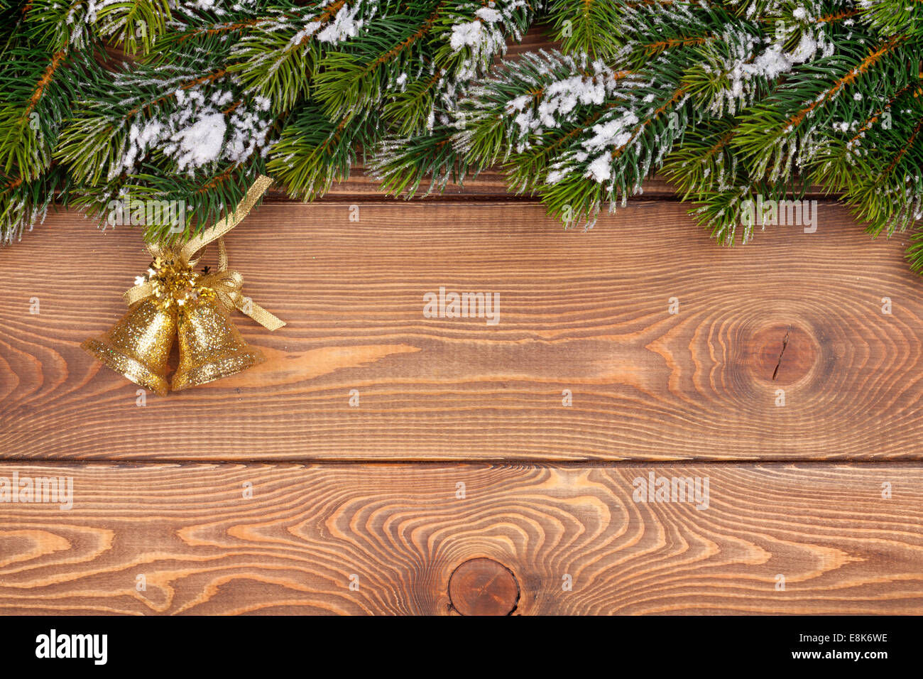 Christmas fir tree with snow and holiday decor on rustic wooden board ...