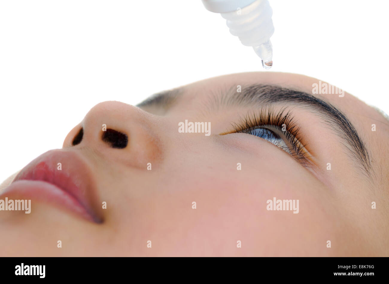 Young girl takes care of her eyes with eye drops. Stock Photo
