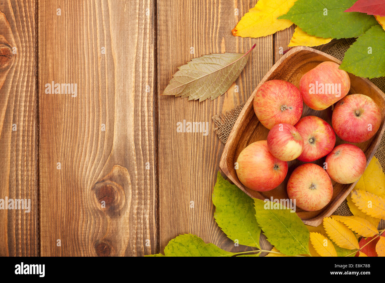 Autumn leaves and apples over wood background with copy space Stock ...