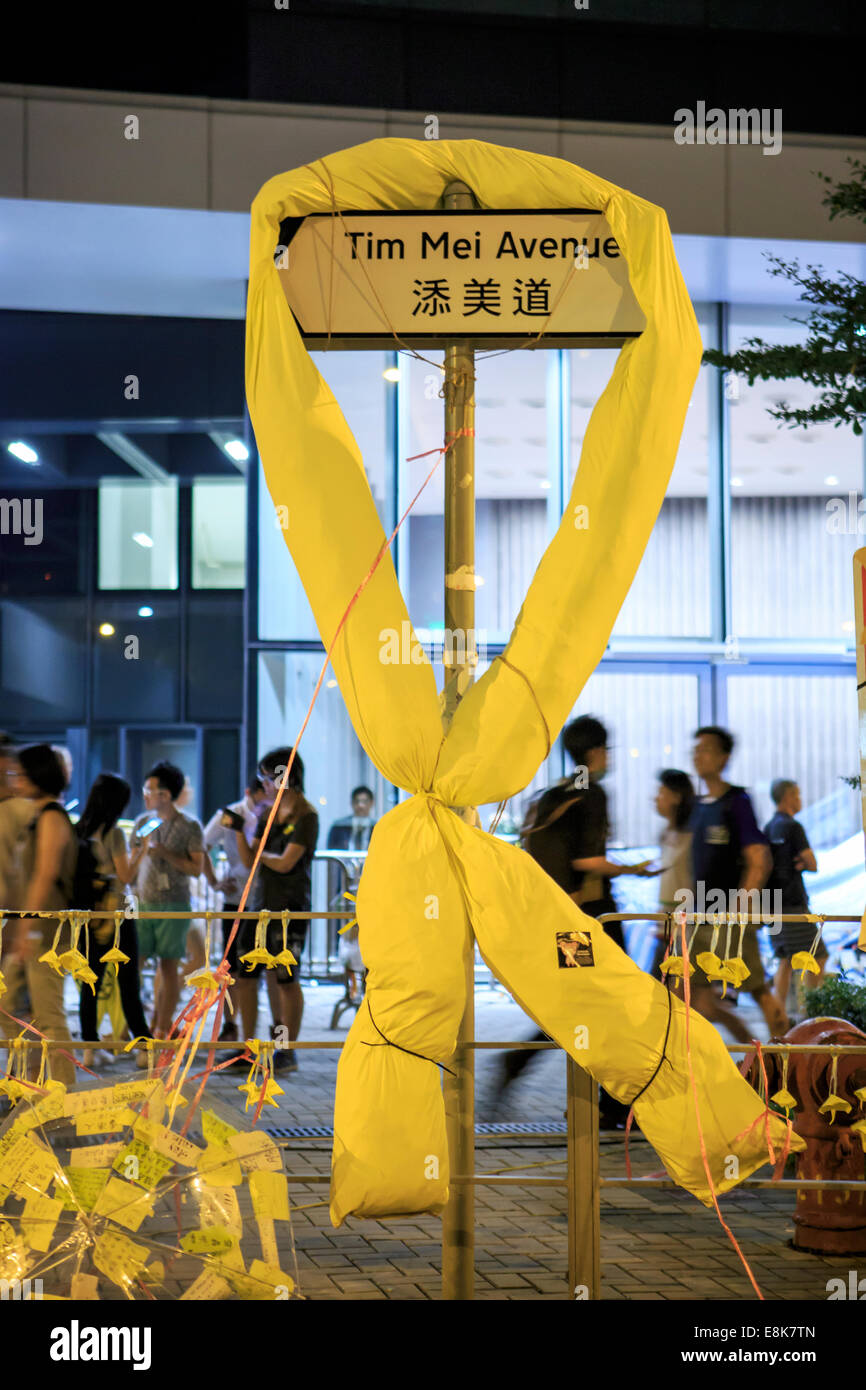 Yellow ribbon tied at the road sign Stock Photo