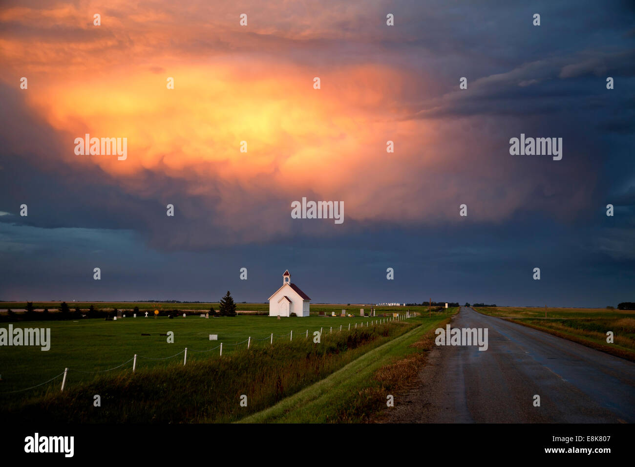 Storm Clouds Saskatchewan with country church and sunset Stock Photo ...