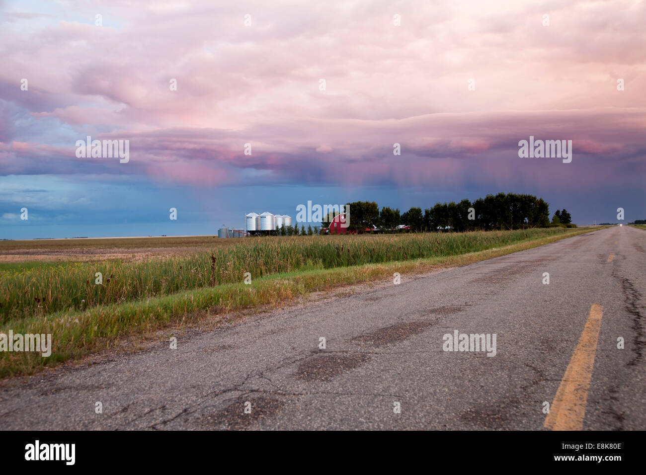 Storm Clouds Saskatchewan and paved road and farm house Stock Photo - Alamy