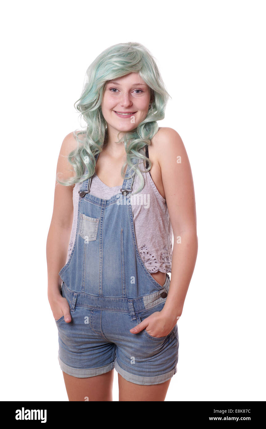 young woman with green hair and jeans dungarees Stock Photo
