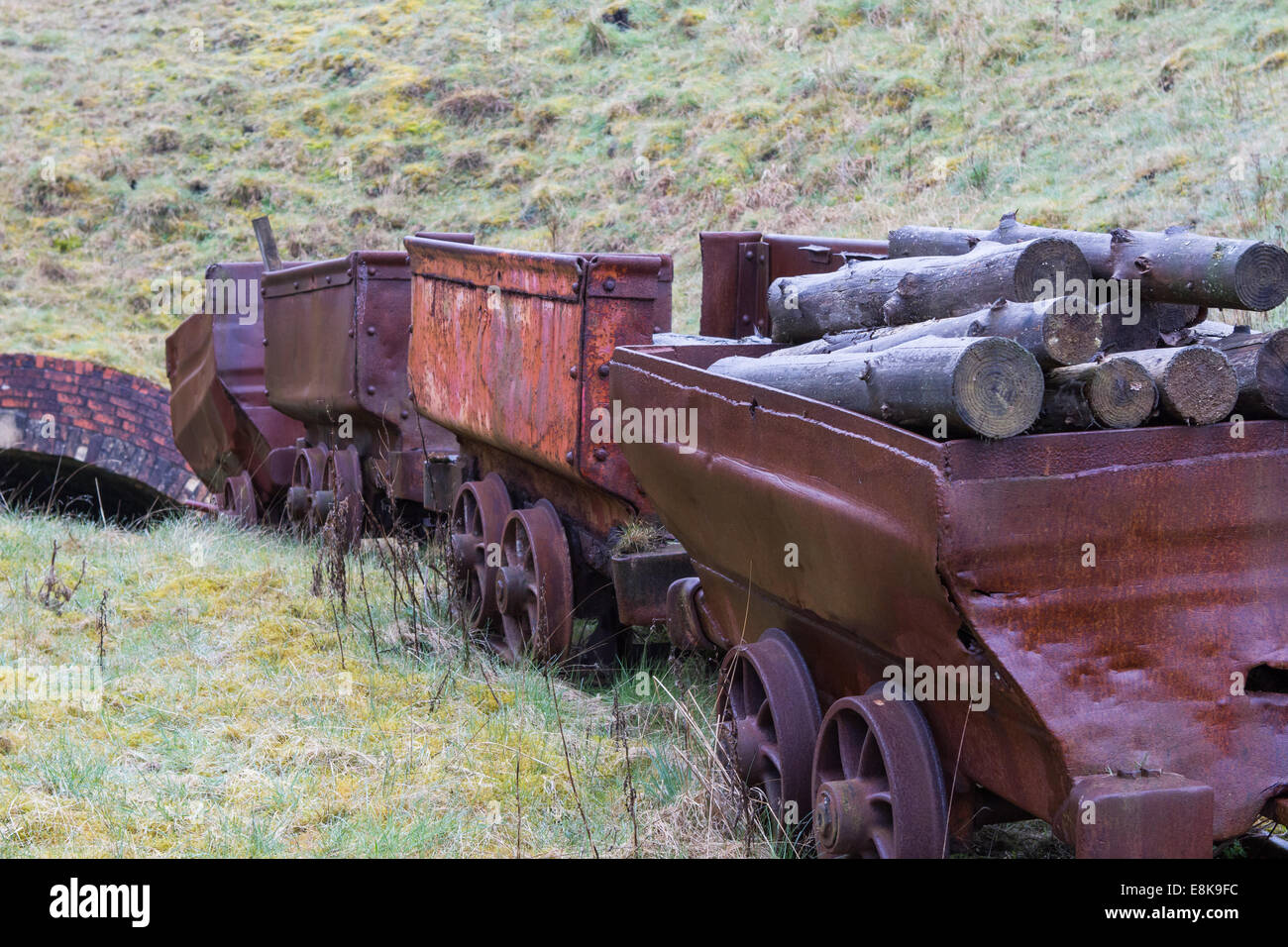 Rusted underground wagons carrying wooden pit props at the big Pit Museum, Blaenavon, Wales, UK Stock Photo
