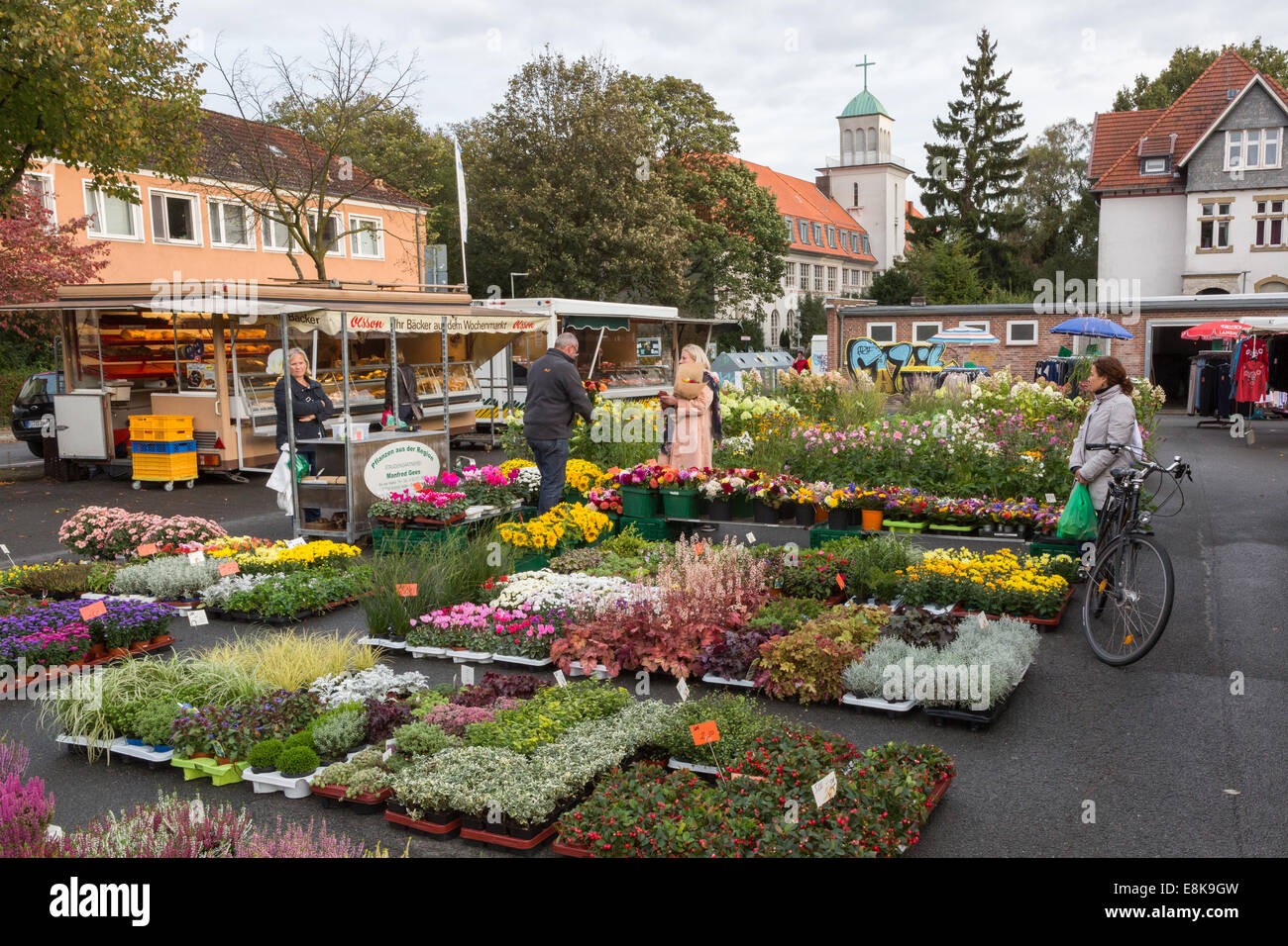Customers at a flower and plant stall at the Jakobuskirchplatz market in Bielefeld, Germany Stock Photo