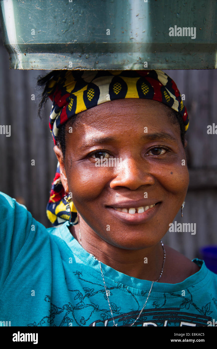Woman of Kroo Bay with bucket on her head, Freetown, Sierra Leone. Photo © Nile Sprague Stock Photo