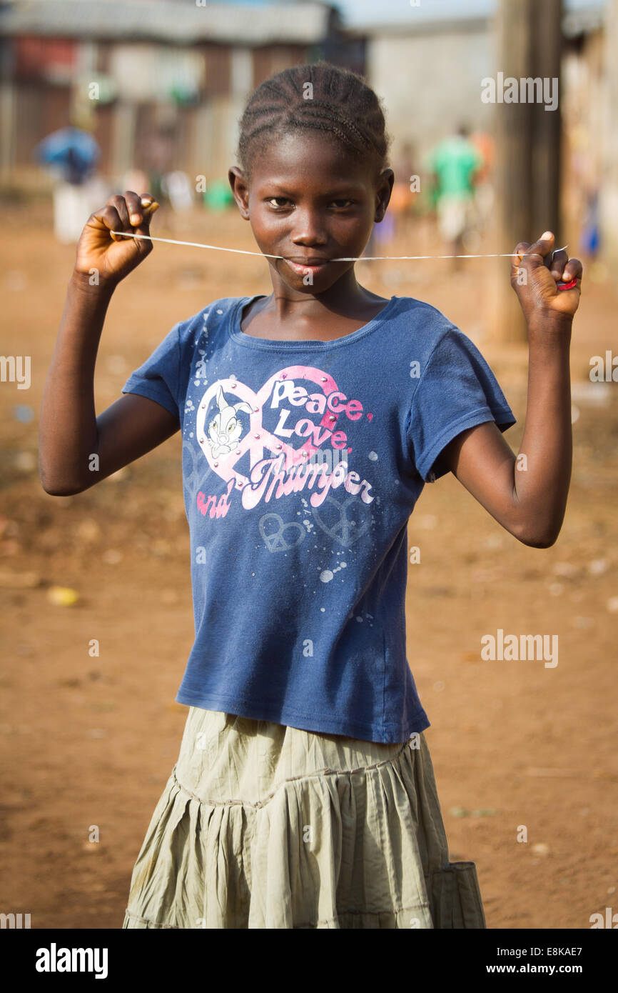 Girl with string between her teeth, Kroo Bay, Freetown, Sierra Leone. Photo © Nile Sprague Stock Photo