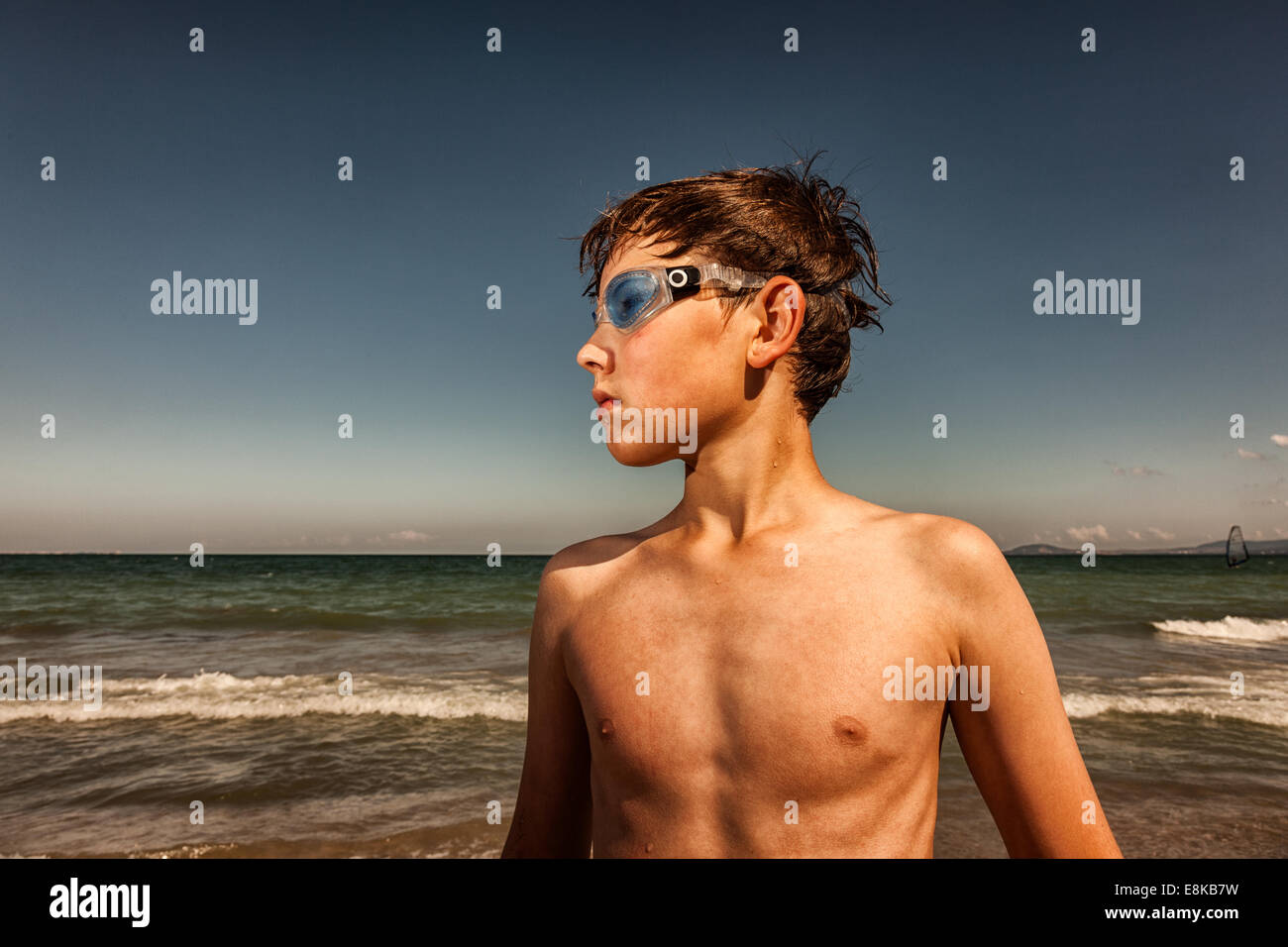 Boy wearing swimming goggles at seaside Stock Photo Alamy