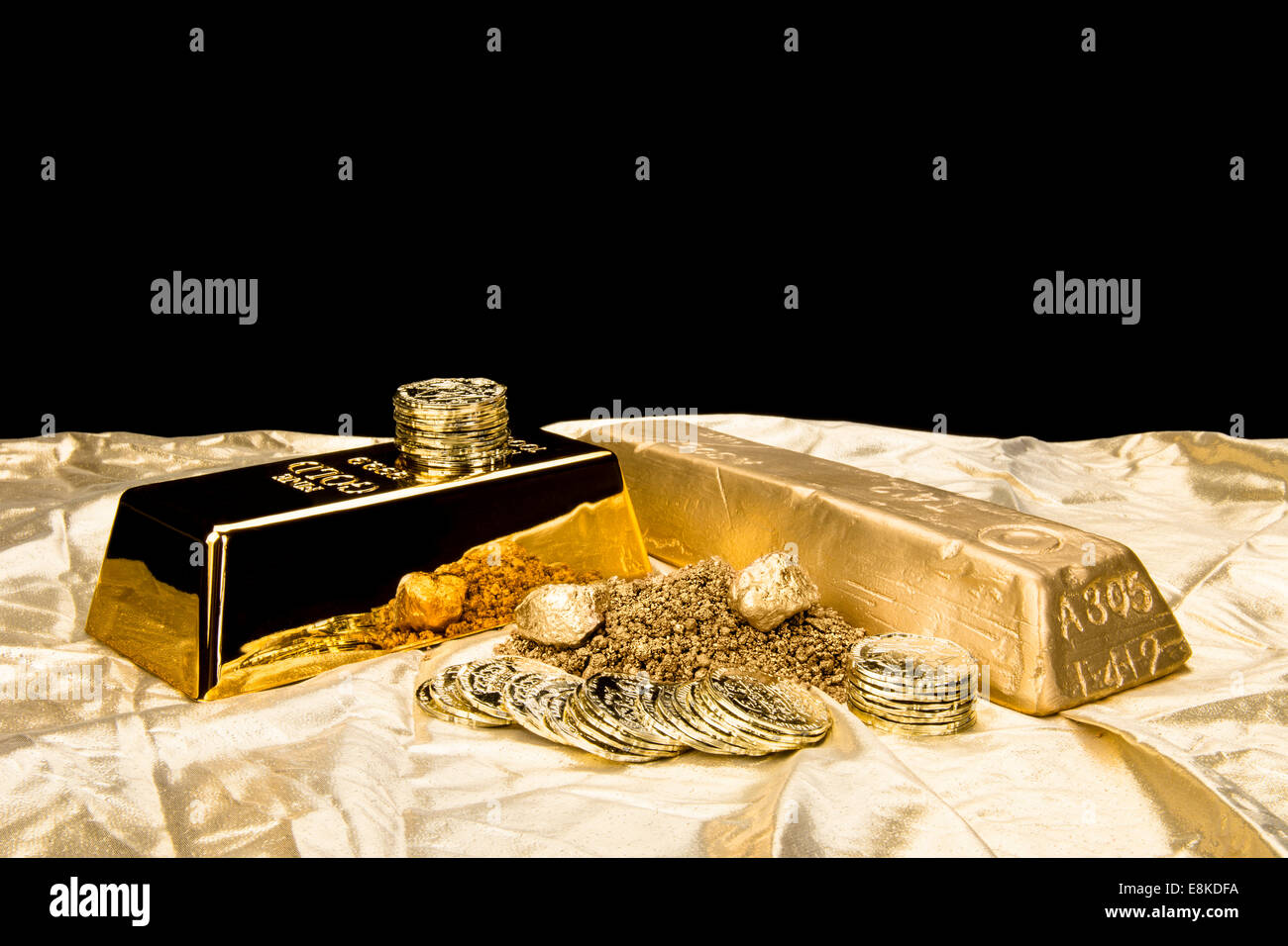 Gold in various forms including dust, nuggets, bar, ingot and coins isolated on a black background for placement of copy Stock Photo