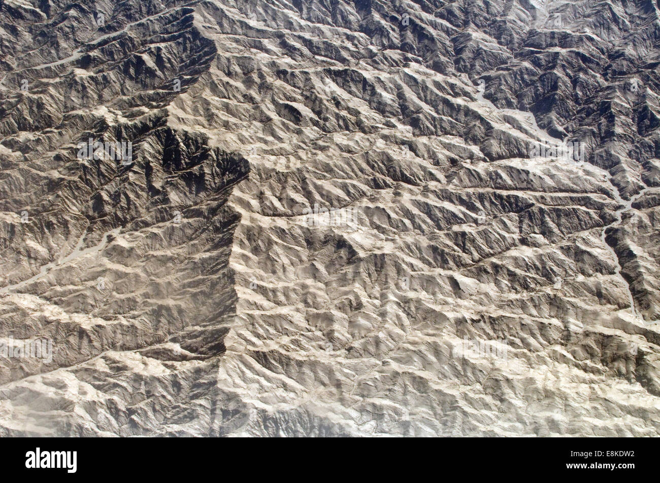 Aerial of a barren mountain ridge edged through the stark landscape ...