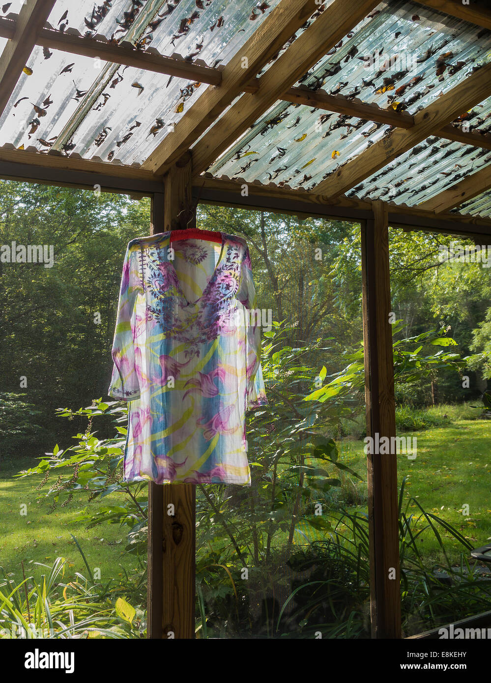 dress drying on hanger in screened porch Stock Photo