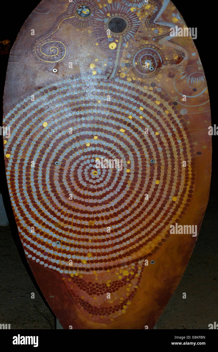 Ceramic painted shield in the Australian Aboriginal style showing a spiral. Australian Indigenous art is oldest unbroken trad' Stock Photo