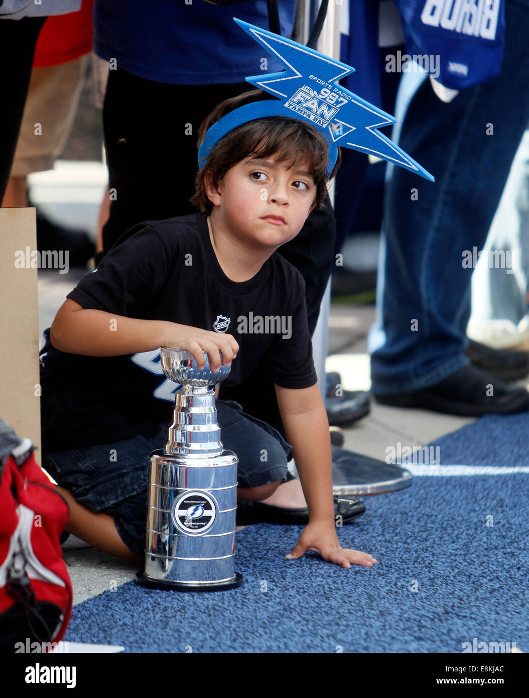 Tampa, Florida, USA. 9th October, 2014. Tampa Bay Lightning fan Lukas Kott, 5, from Tampa, clutches his miniature Stanley Cup while waiting for Lightning players to arrive on the ''blue carpet'' before taking on the Florida Panthers on opening night at the Times Forum in Tampa Thursday evening (10/6/14). HIs favorite player is Steven Stamkos, his older sister Brittanty Kott said. ''He's obsessed, he wants to be like him. © ZUMA Press, Inc/Alamy Live News © ZUMA Press, Inc/Alamy Live News Stock Photo