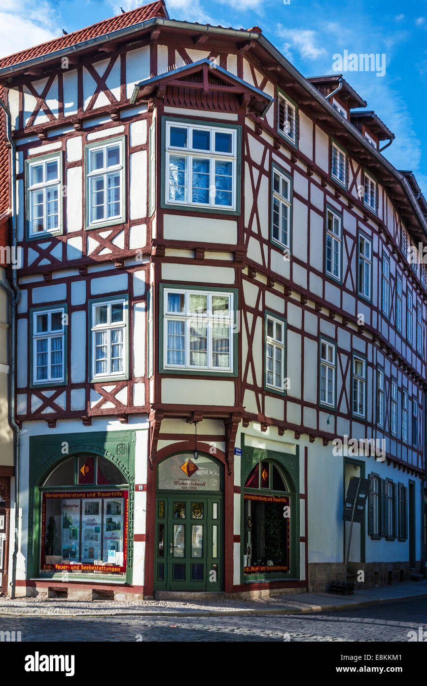 Corner of a half-timbered medieval house and funeral directors in the UNESCO World Heritage town of Quedlinburg, Germany. Stock Photo