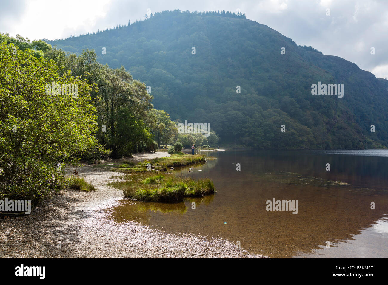 The shores of the Upper Lake at the old monastic settlement of Glendalough, County Wicklow, Republic of Ireland Stock Photo