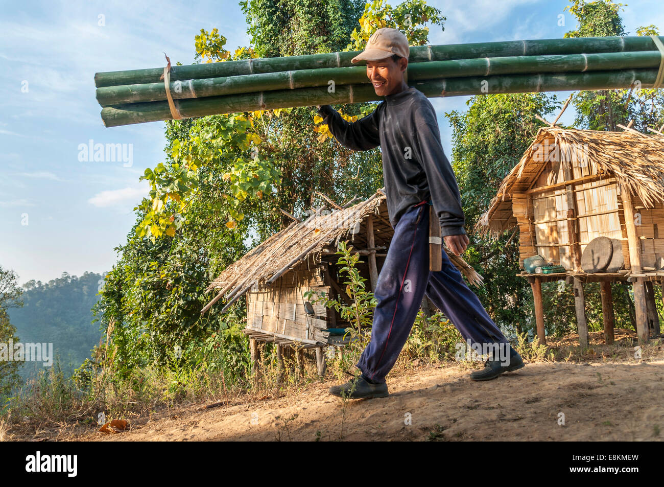 Man from the Lahu people, hill tribe, ethnic minority, carrying bamboo  poles, Mae Hong Song Province, Northern Thailand Stock Photo - Alamy