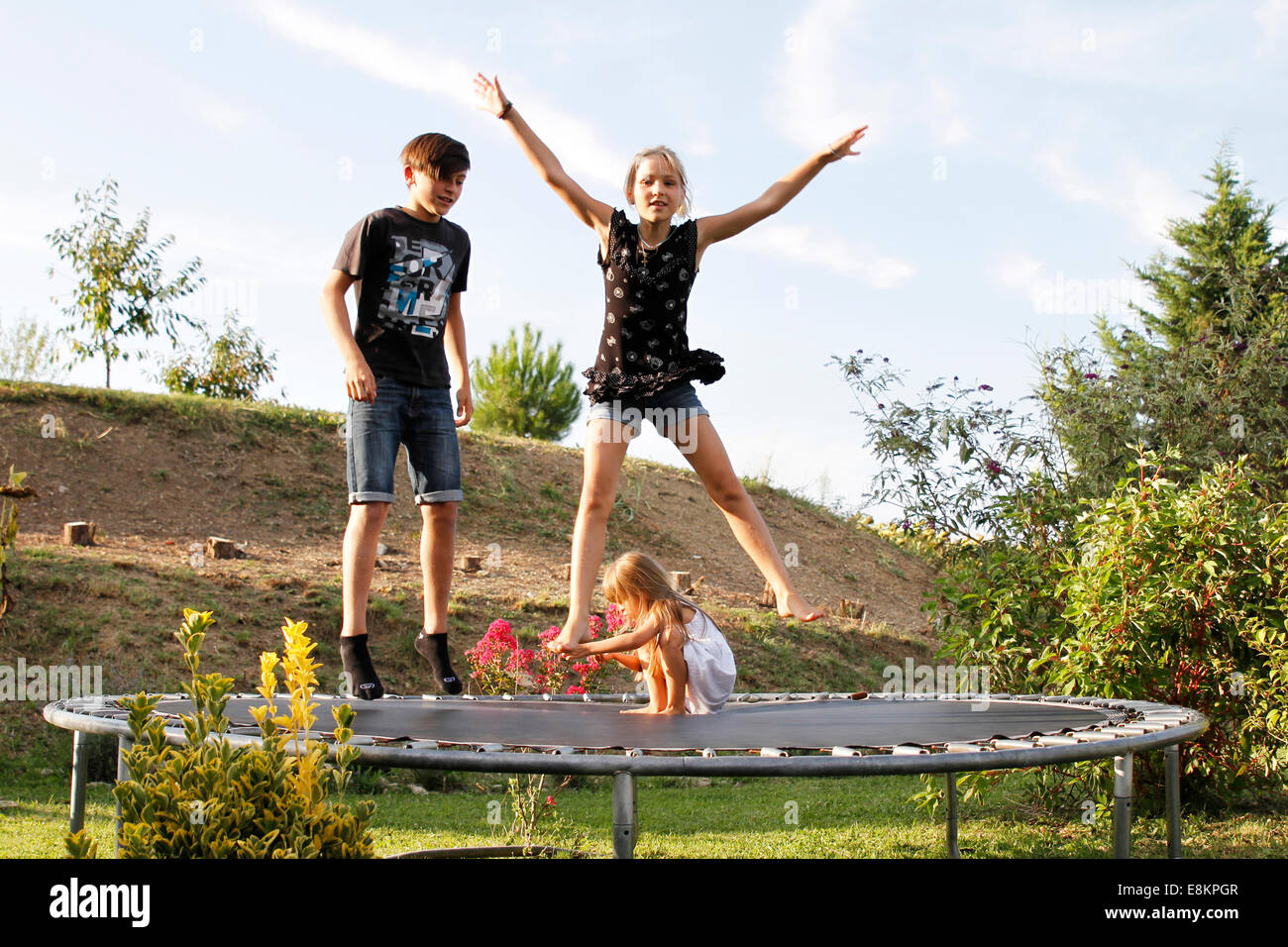 Children playing on a trampoline. Stock Photo