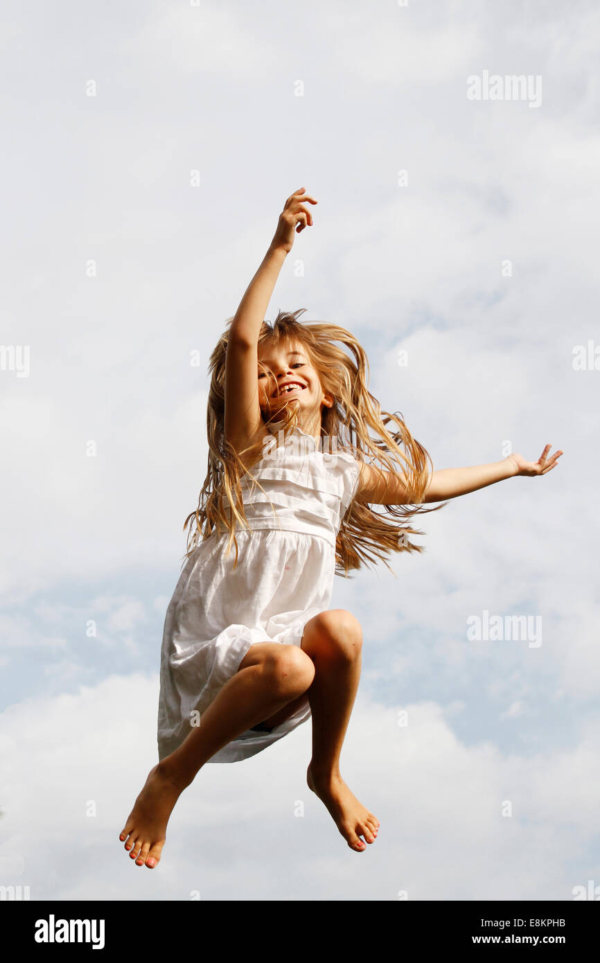 A 6-year old girl on a trampoline. Stock Photo