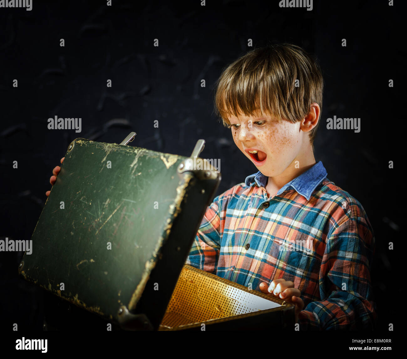 Little boy finding treasure inside a suitcase Stock Photo Alamy