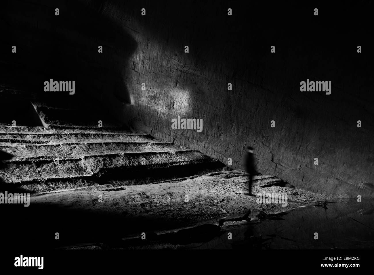 Person inside a large cave Stock Photo