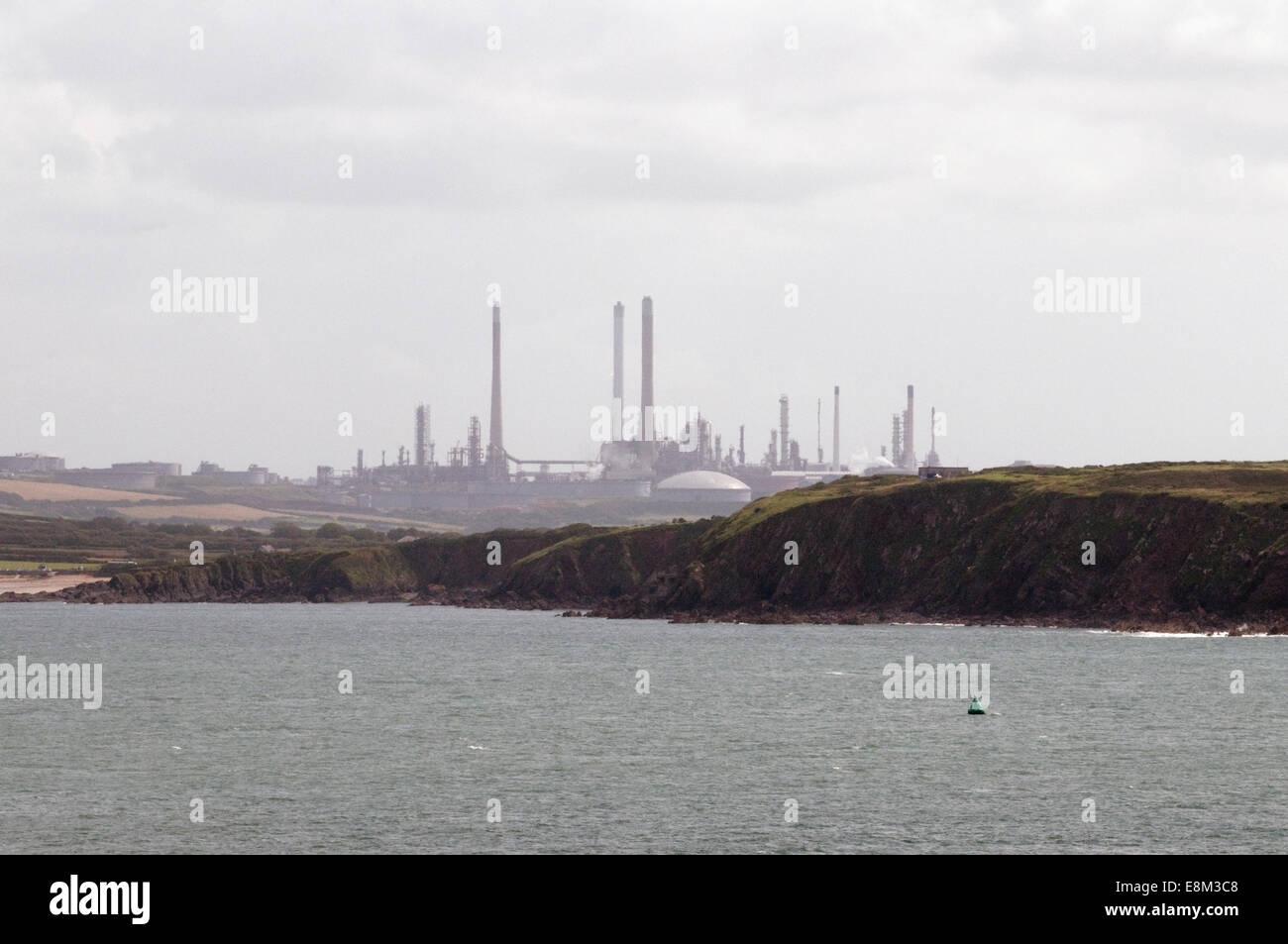 Milford Haven Oil Refinery Pembrokeshire viewed from Dale headland across the estuary waters Stock Photo
