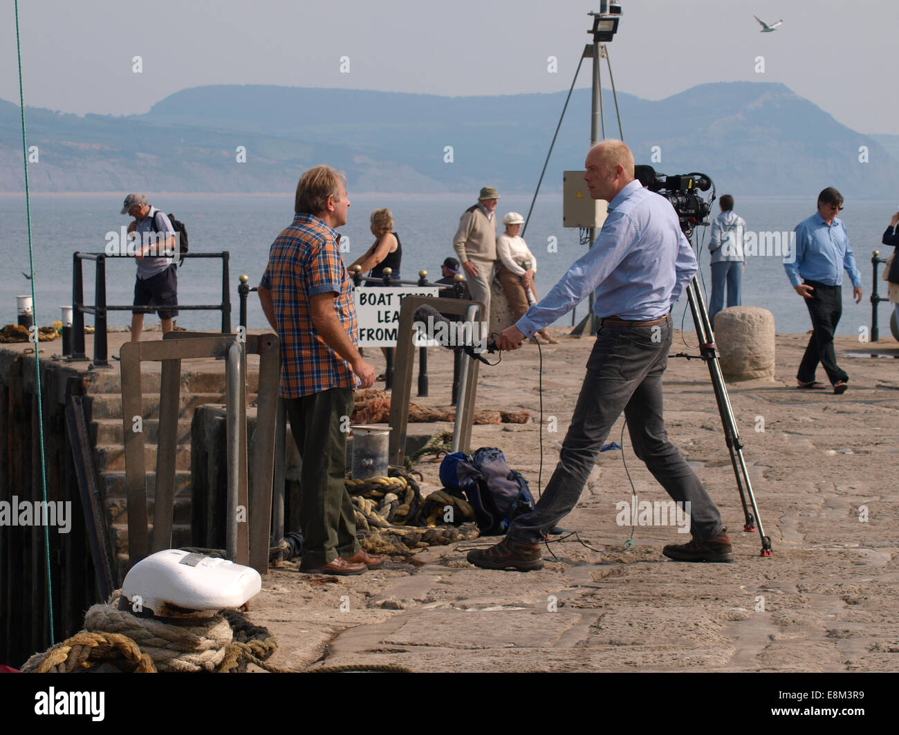 TV interview being conducted on the Cob, Lyme Regis, Dorset, UK Stock Photo