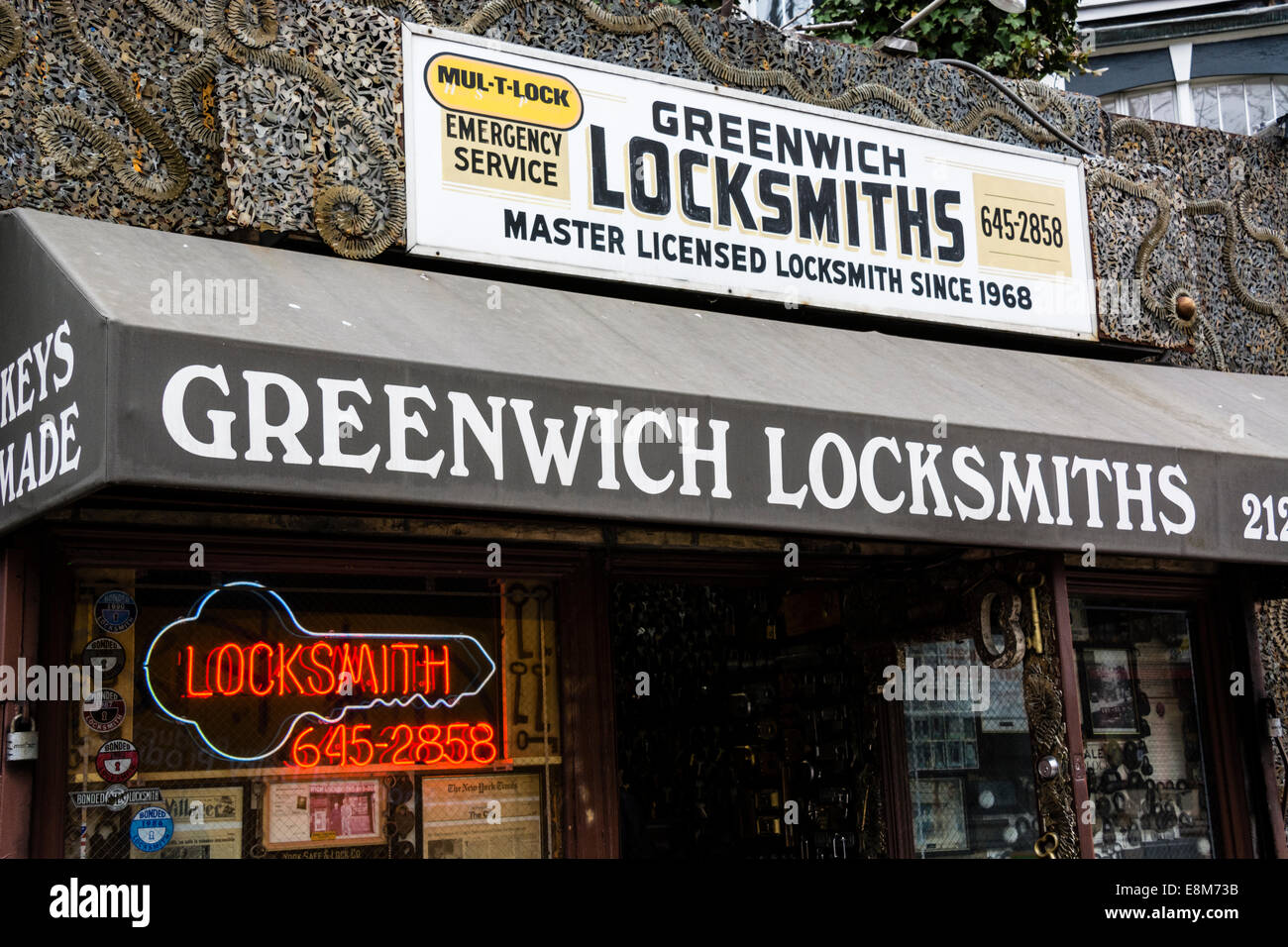 Locksmith shop in Greenwich Village, New York, with facade of metal sculpture made with keys by the owner, Phil Mortillaro. Stock Photo