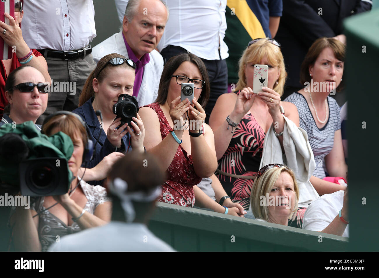 Female fans taking a photo of a player at Wimbledon Championships 2014, Stock Photo