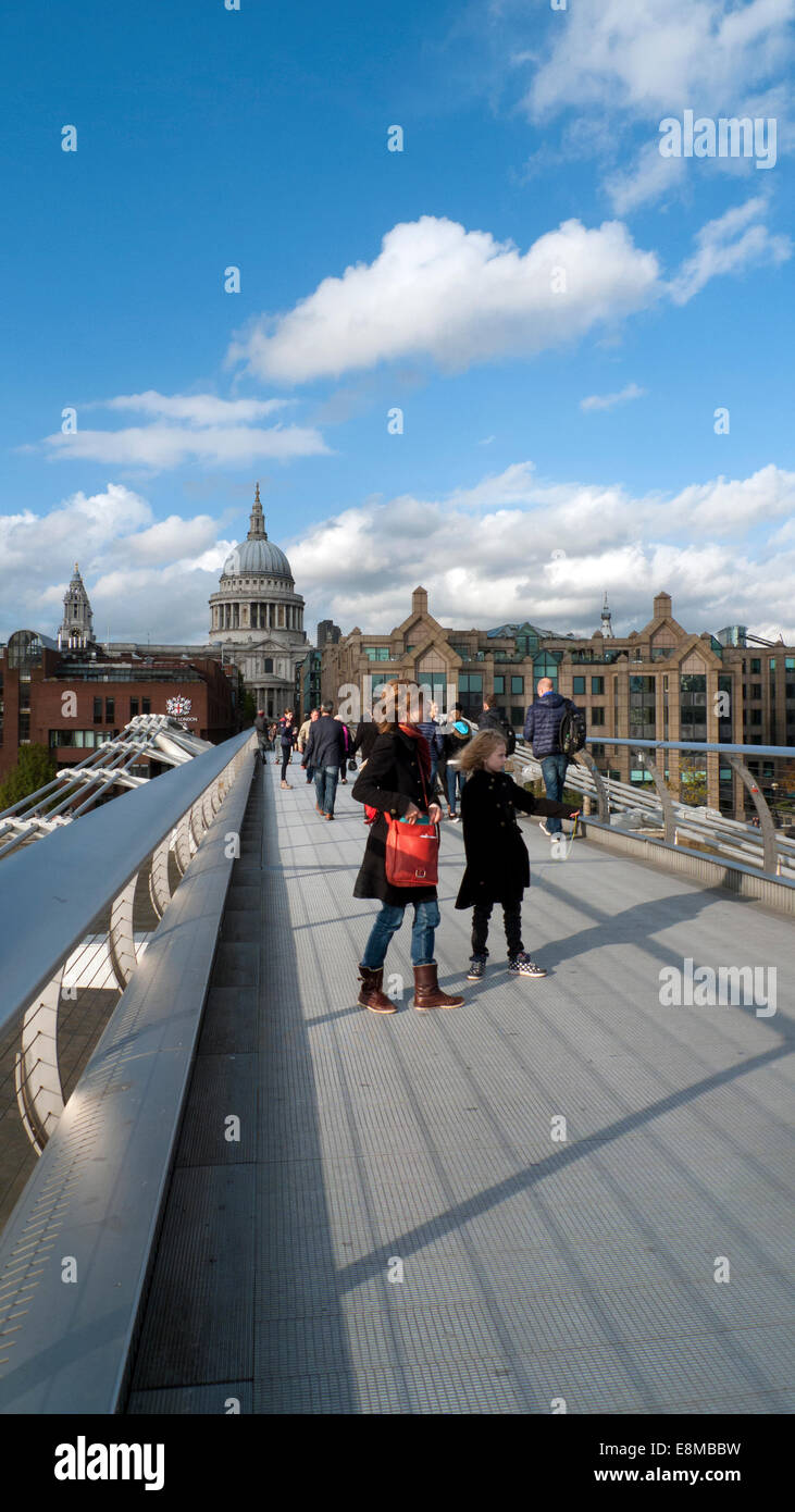 Millennium Bridge, London UK. 10th October 2014.  People late Friday afternoon enjoying the autumn sunshine as they cross the Millennium  or 'wobbly' Bridge which joins the North and South banks of the River Thames.  The forecast for London tomorrow is for a mixture of scattered thundery showers and sunny spells in the afternoon. Credit:  Kathy deWitt/Alamy Live News Stock Photo