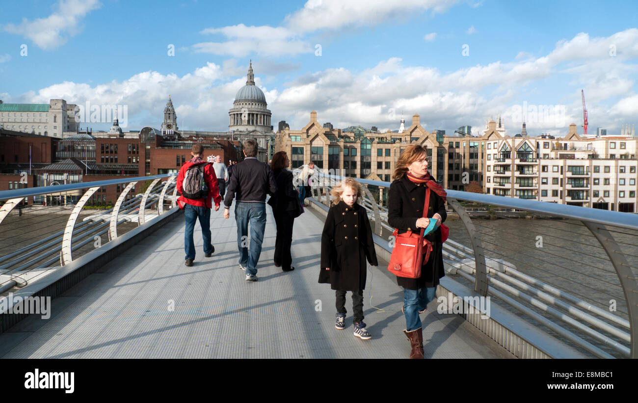 People walk across the Millennium Bridge over the River Thames in on a sunny autumn day in London England UK  KATHY DEWITT Stock Photo