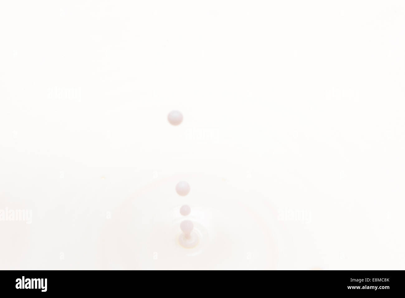 drop of milk falling and splashing Stock Photo