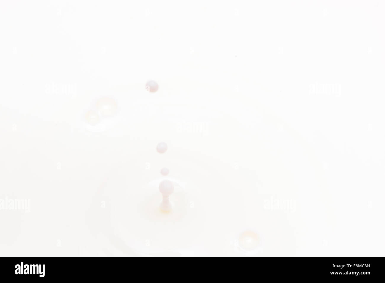drop of milk falling and splashing Stock Photo