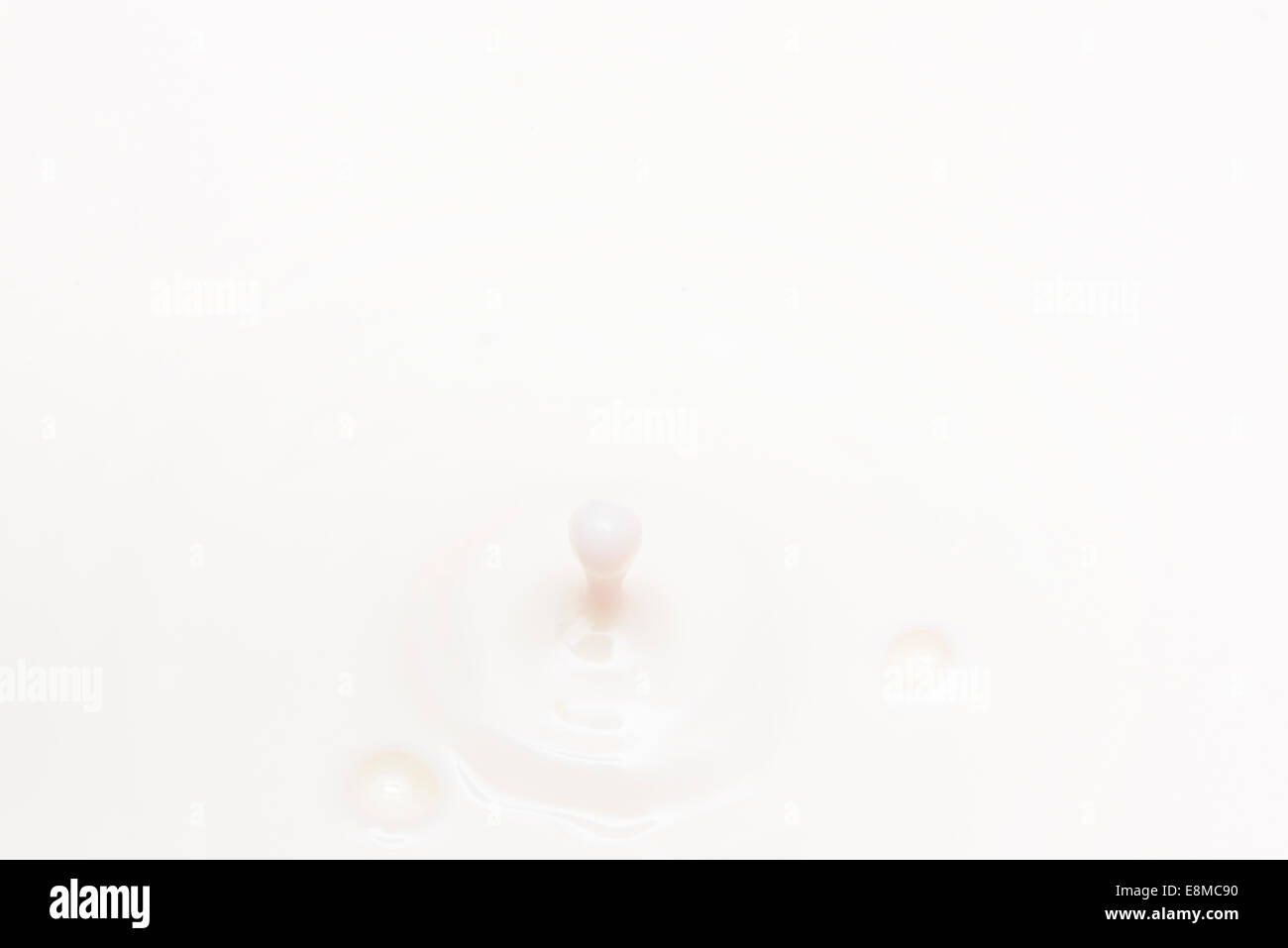 drop of milk falling and splashing Stock Photo