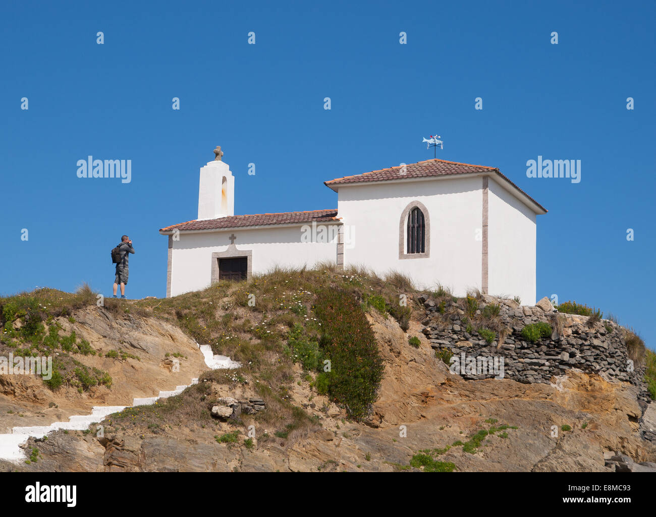 Little chapel and man in Valdovino, Galicia, Spain. Stock Photo