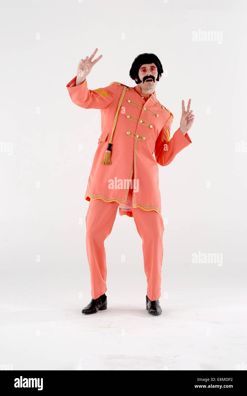 man in fancy dress comedy costume in Sargent Peppers military outfit as the Beatles from their famous album cover Stock Photo