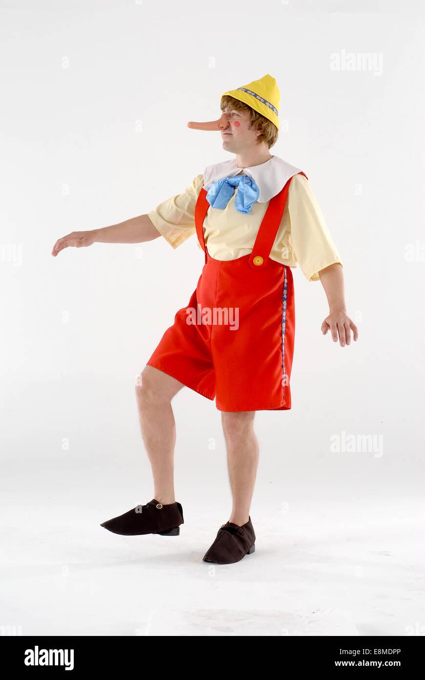 man in fancy dress comedy costume as Pinocchio, from the disney cartoon  character in popular culture Stock Photo - Alamy