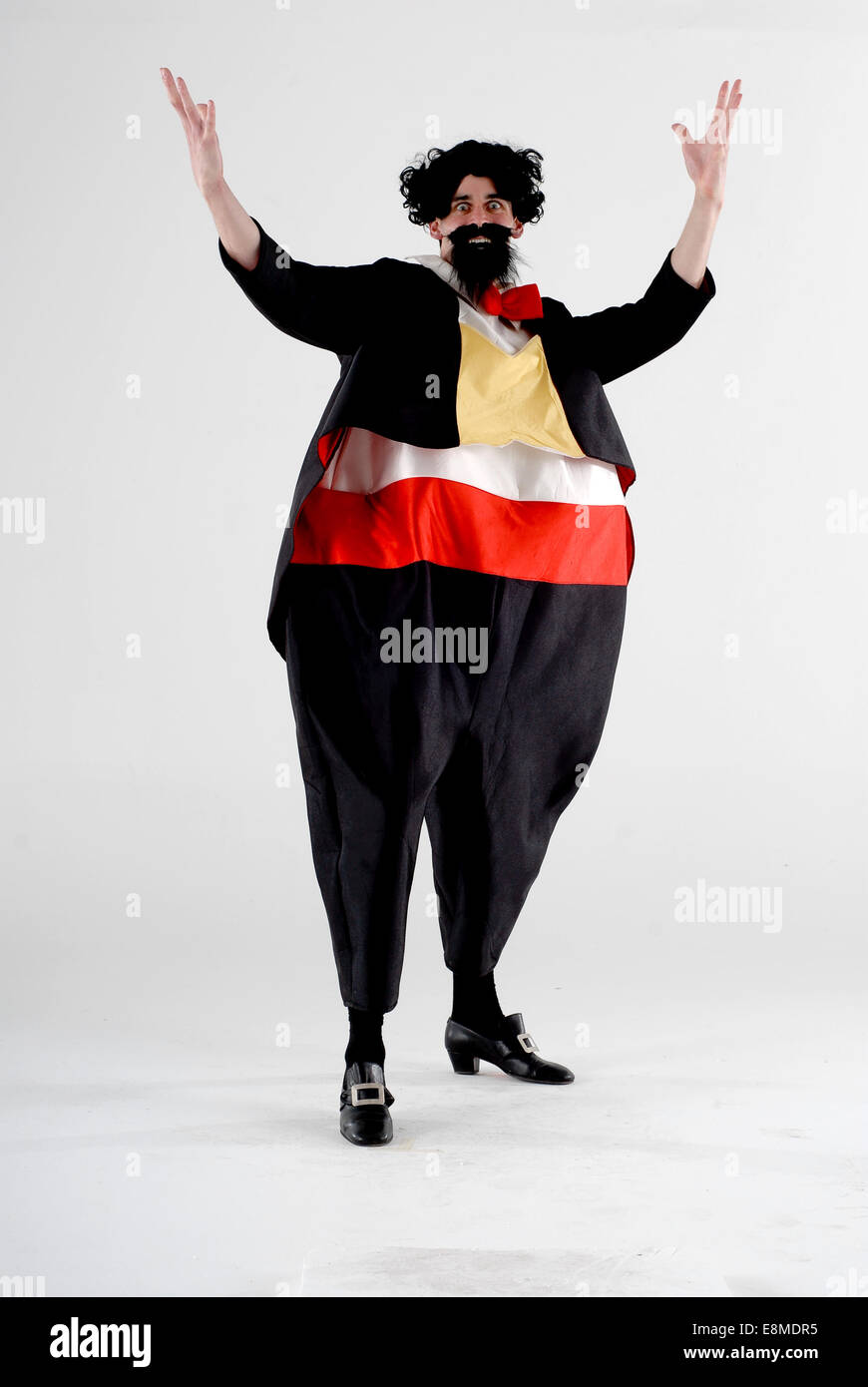 man in fancy dress comedy costume as pavarotti opera singer, with fat suit,  wig, beard. Also looks like the go compare advert Stock Photo - Alamy