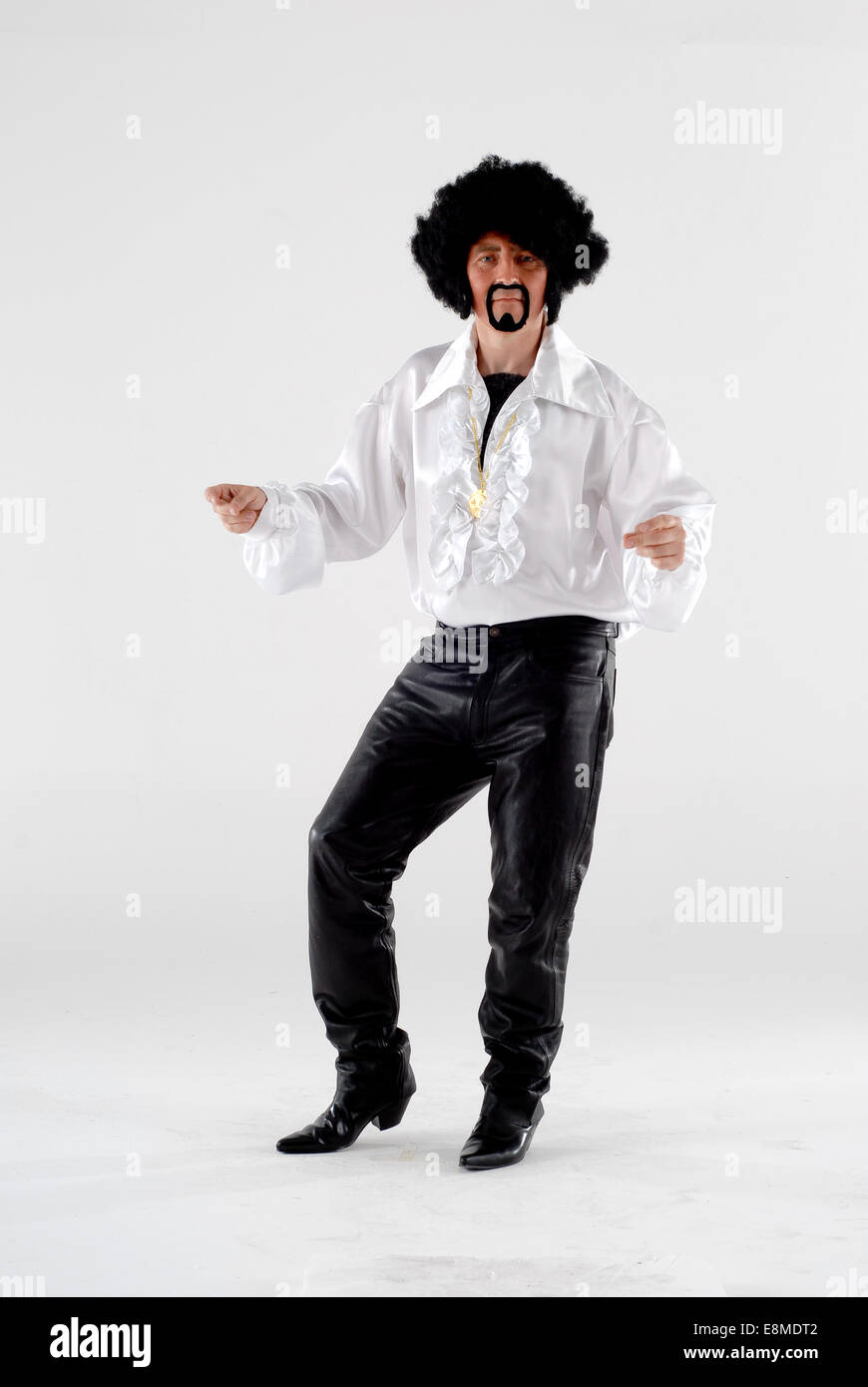 man in fancy dress comedy costume in full tom jones, the singer outfit with  black wig, goatee, leather trousers & frilly shirt Stock Photo - Alamy