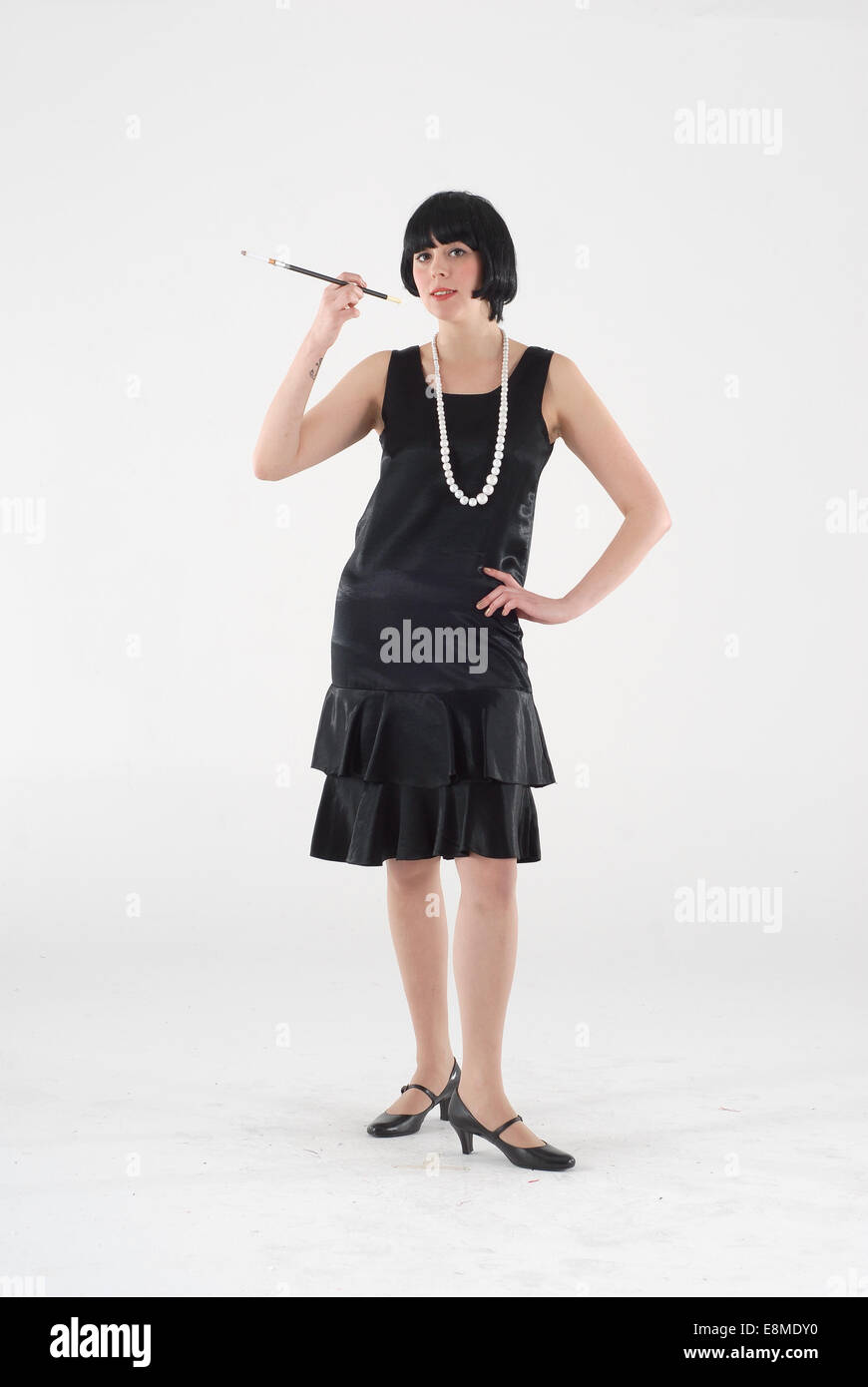 Woman in fancy dress comedy costume in a 1920s flapper fashion outfit Stock Photo