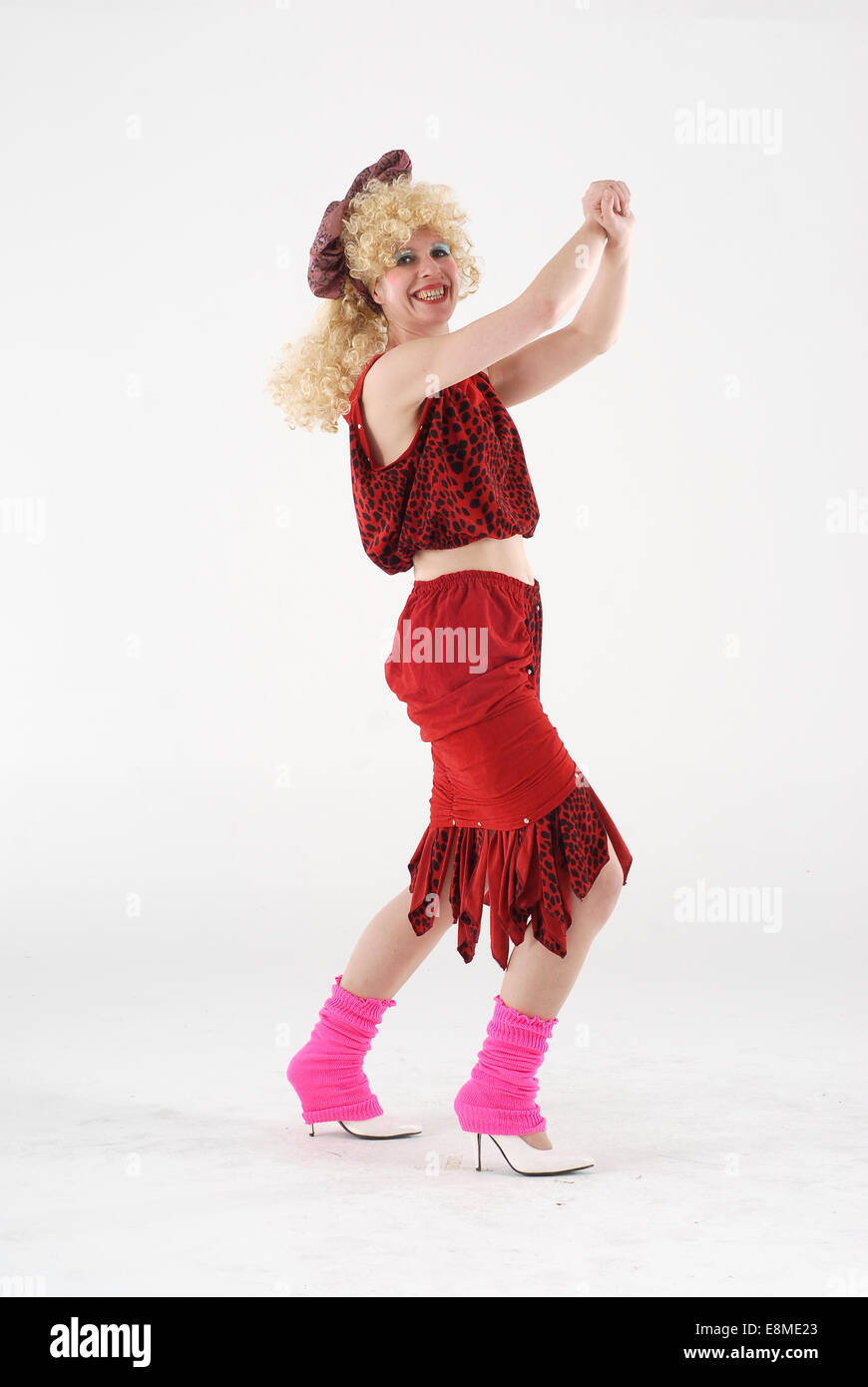 woman in fancy dress comedy costume in 1980s disco fashion and crazy outfit Stock Photo