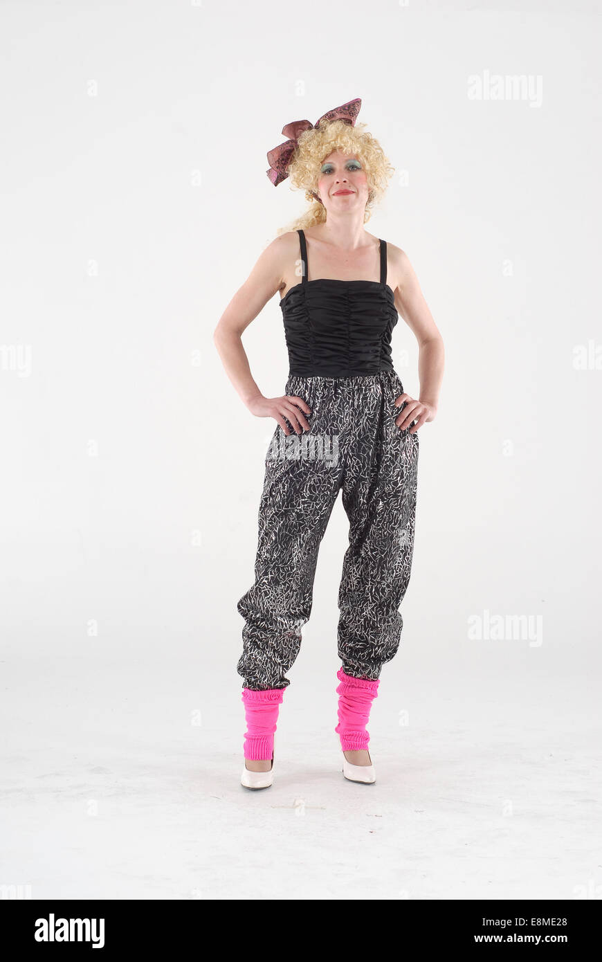 woman in fancy dress comedy costume in 1980s disco fashion and crazy outfit Stock Photo