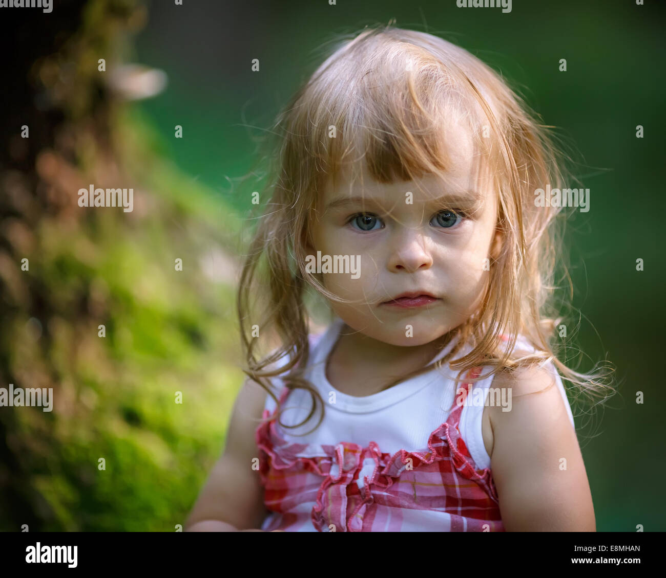 Little girl in the forest Stock Photo - Alamy