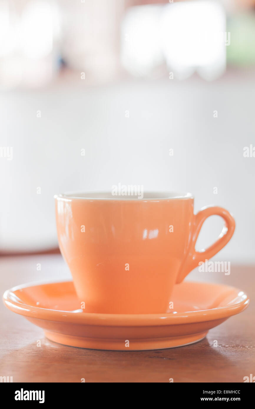 Orange coffee mug with some smoke viewd from up angle on Craiyon